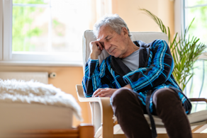 Life Assure Senior Woman Sitting In Chair And Laughing With Caregiver Nurse Blog